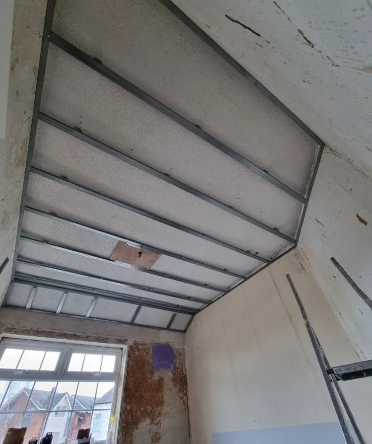 Conservatory roof being lined with battens and insulation