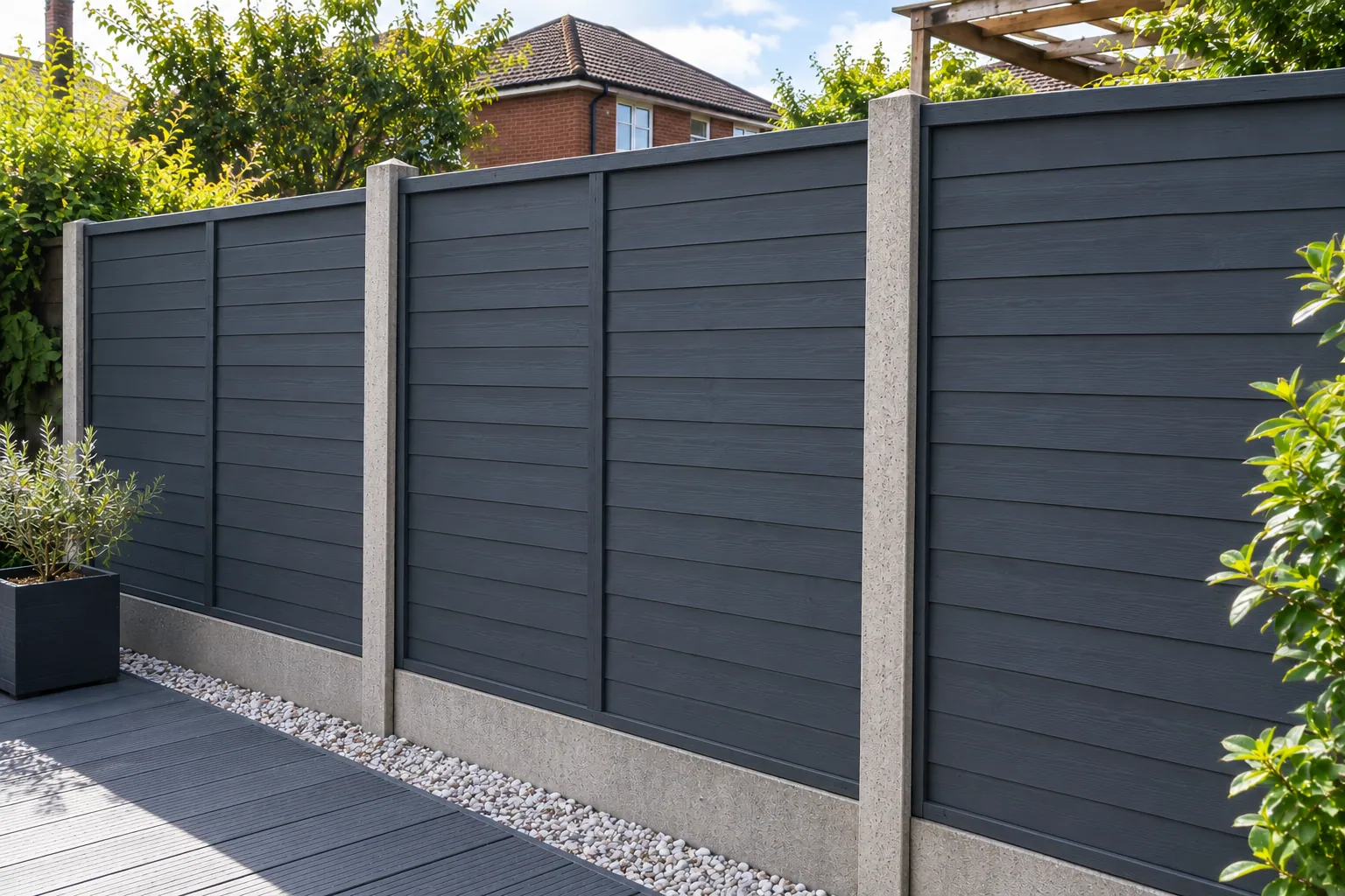 The same garden fence after restoration, painted dark graphite grey
