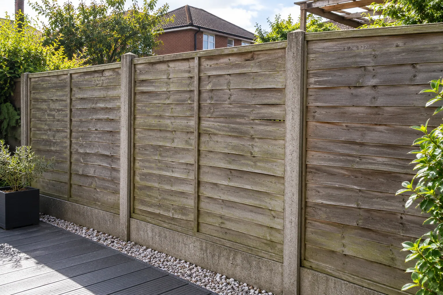 Weathered, faded timber garden fence before restoration