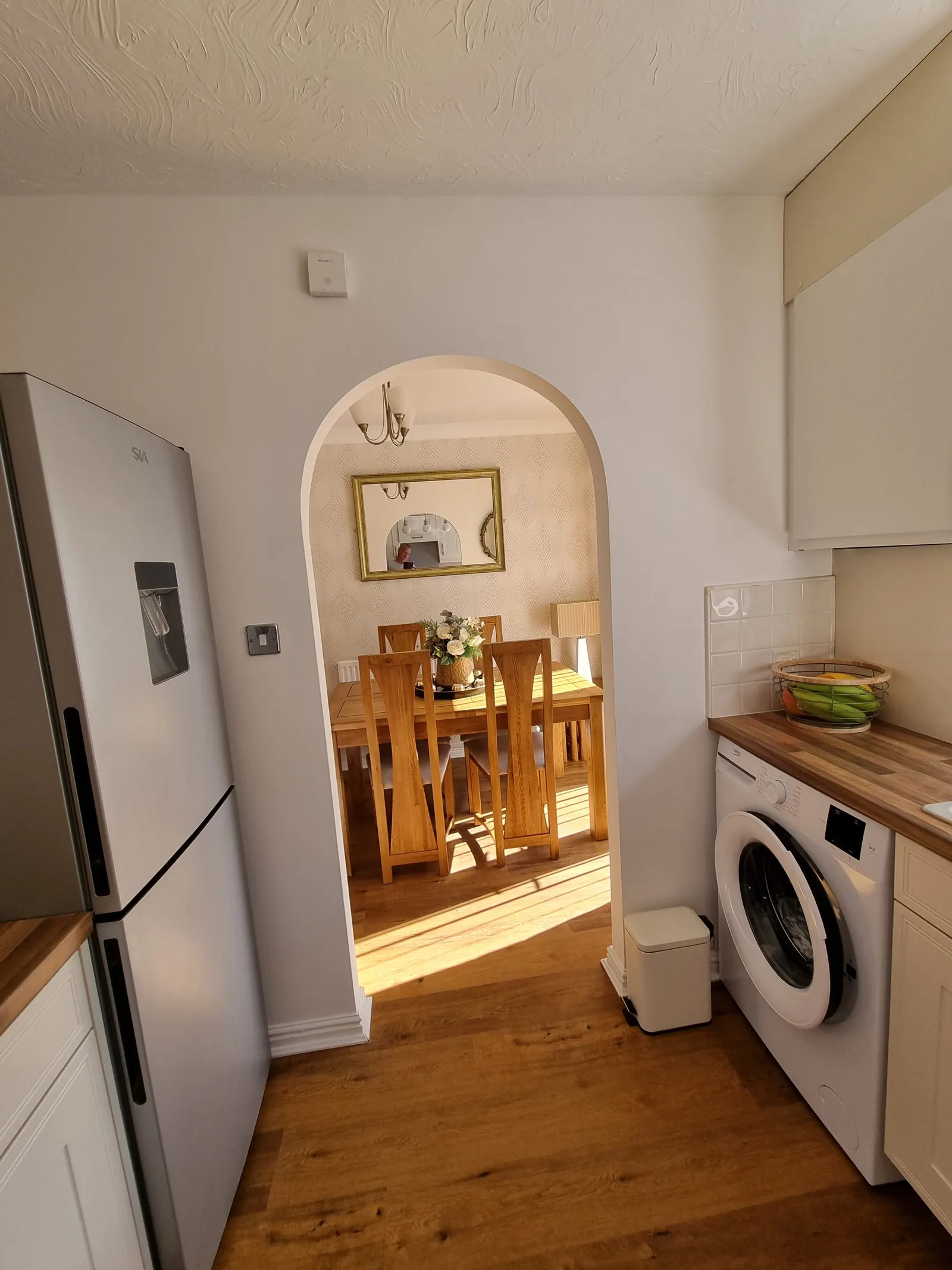 Kitchen with an archway through to the dining room