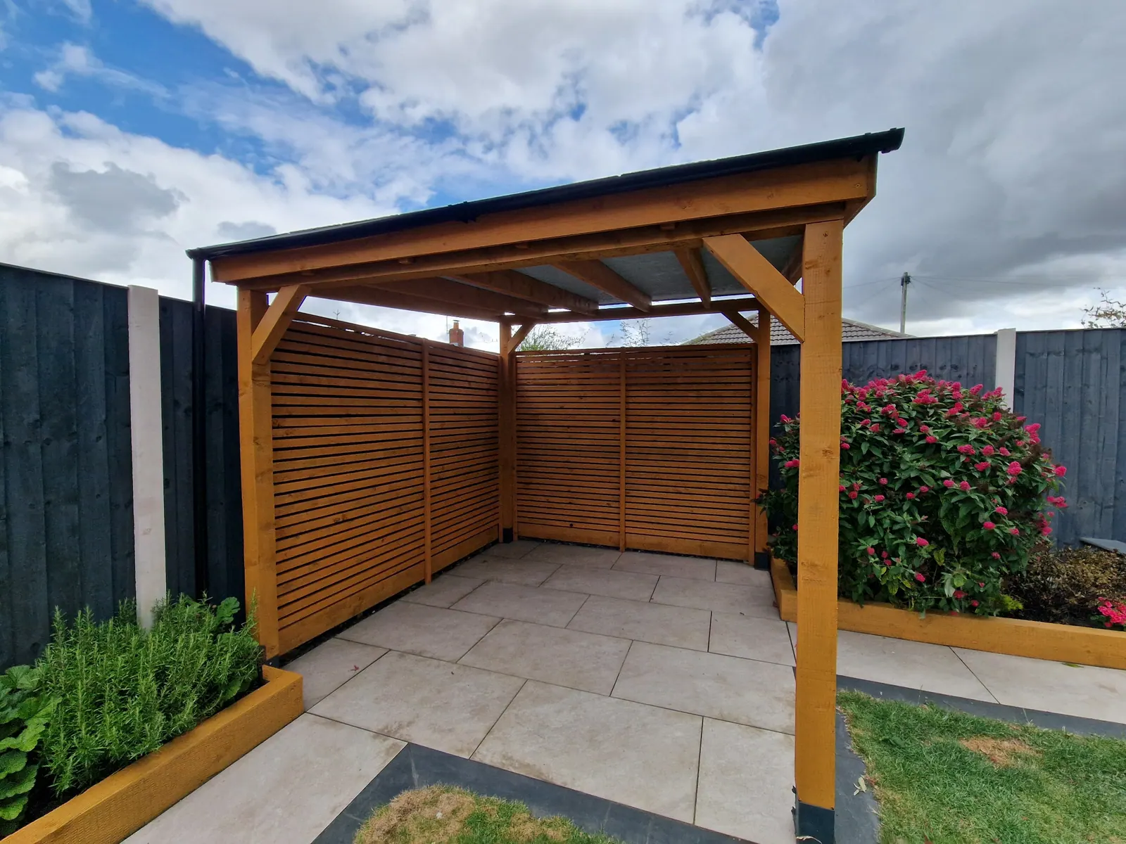 Timber pergola with a slatted screen over a paved patio