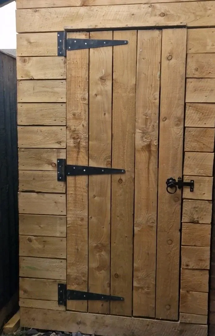 Ledged timber shed door with black hinges